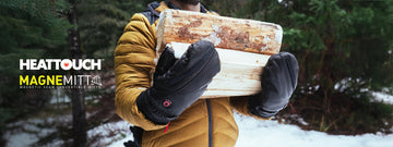 Hands wearing heattouch hellfire magne mitts carrying logs of wood